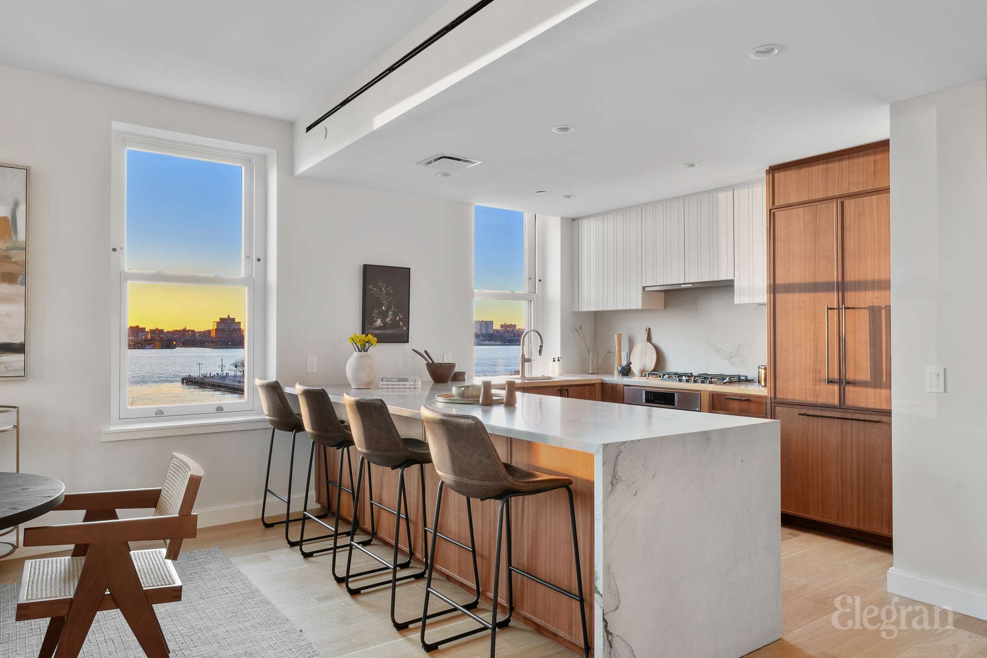 150 Barrow Street, Unit PHA Manhattan, NY 10014 - Photo 9 of 22 a kitchen with a dining table chairs and refrigerator
