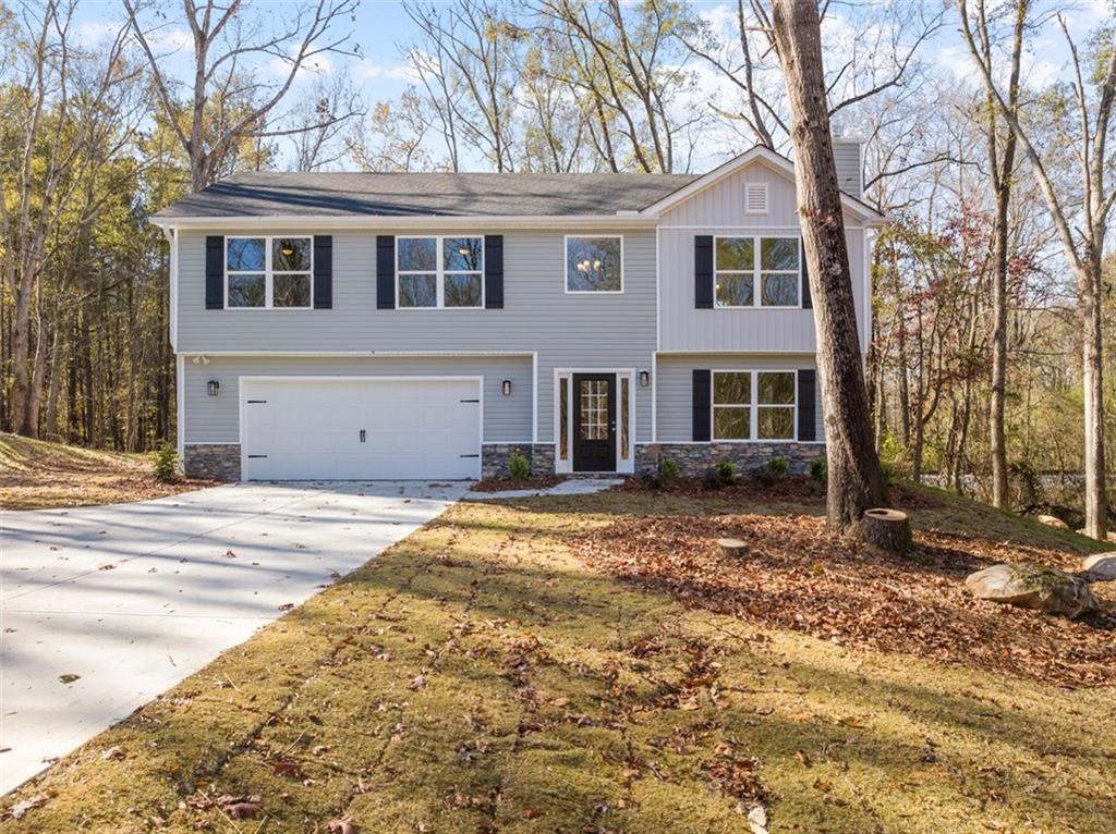a view of a house with a backyard