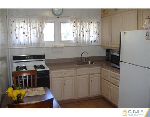 7 Ridge Road Old Bridge, NJ 08857 - Photo 7 of 15 a kitchen with appliances cabinets and a window