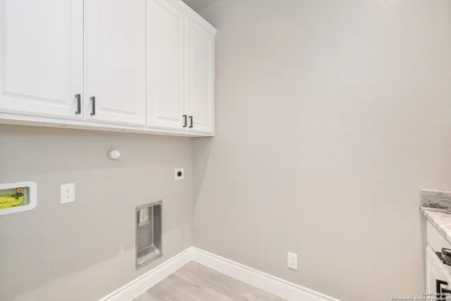 a bathroom with a granite countertop sink toilet and mirror