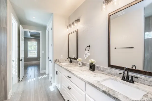 a view of a hallway with wooden floor and closet
