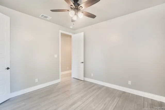 a bathroom with a granite countertop sink toilet a mirror and shower
