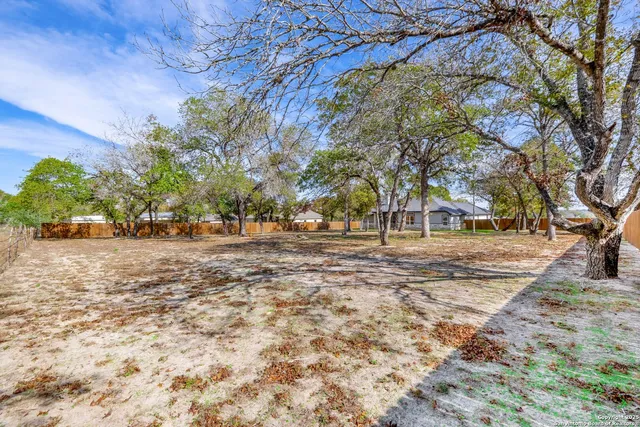 front view of a house with a yard and trees