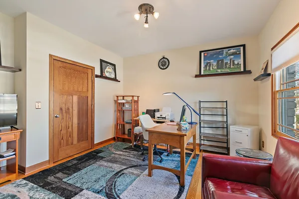 a living room with furniture a rug and a window
