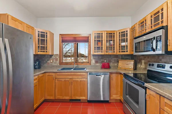 a kitchen with stainless steel appliances granite countertop a stove top oven