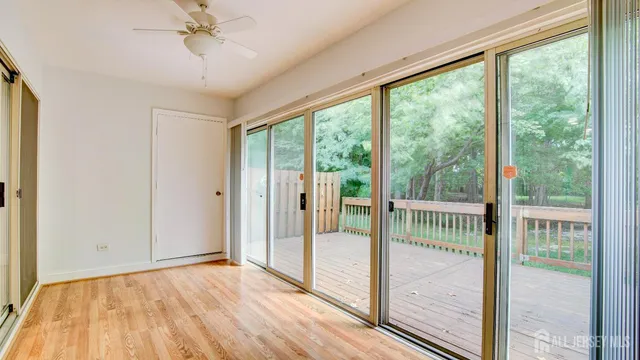 a view of a room with wooden floor and balcony