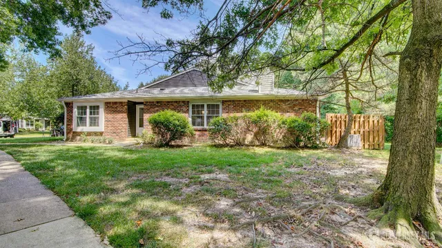 a view of a house with yard and a garden