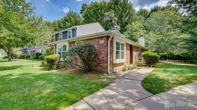 a view of a house with yard and a garden