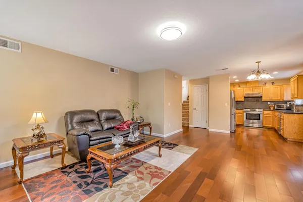 a living room with furniture and kitchen view