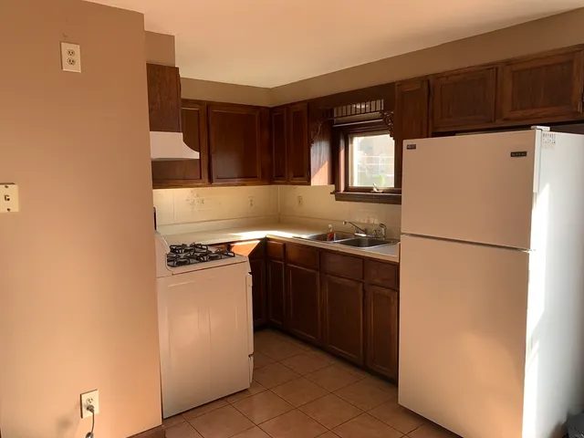 a kitchen with a refrigerator and a stove