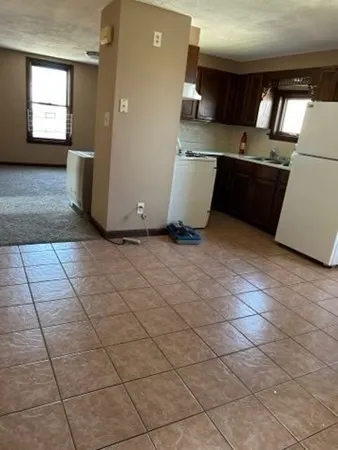a kitchen with a sink a stove and a refrigerator