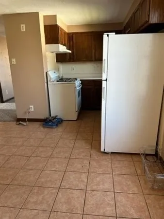 a room with a refrigerator and a stove