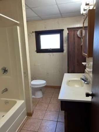 a bathroom with a sink toilet and tub