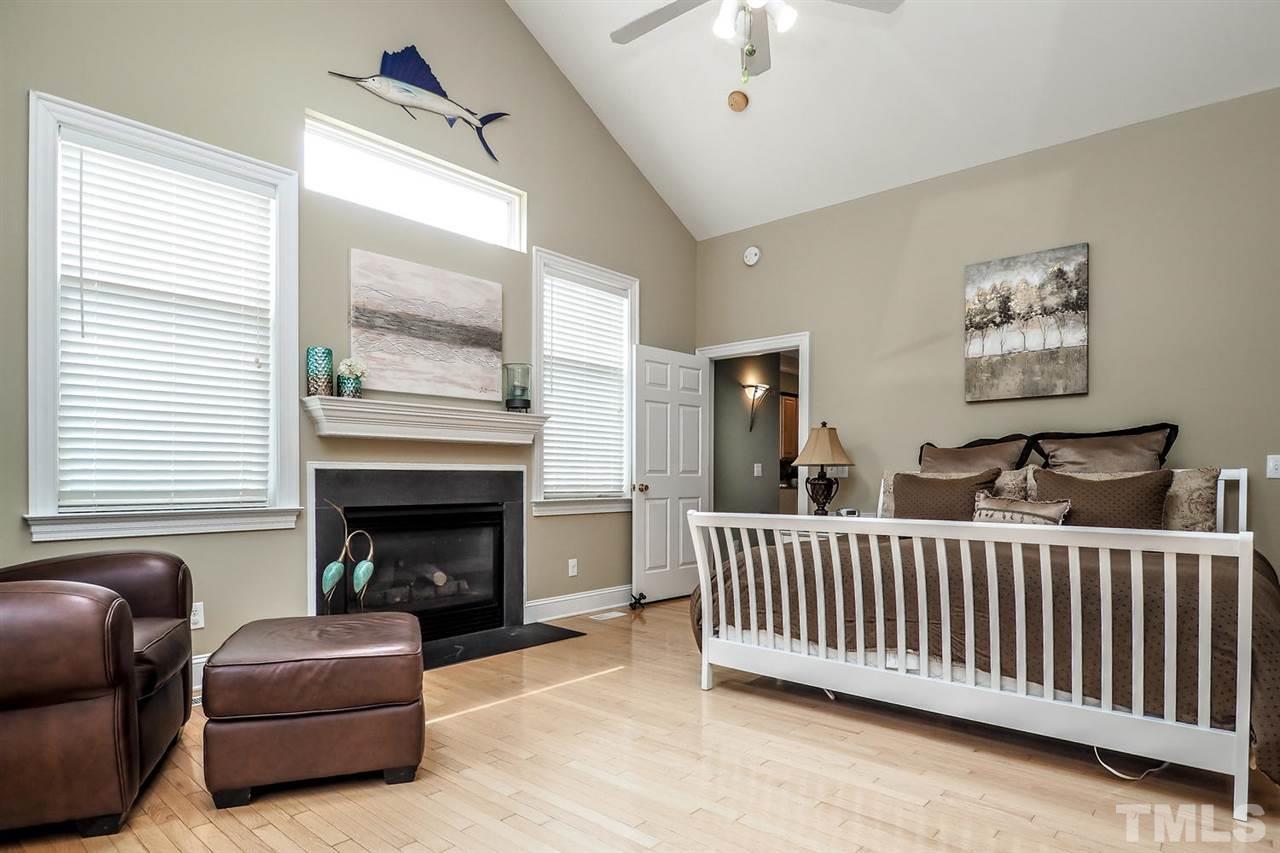 299 Howard Tant Road Zebulon, NC 27597 - Photo 12 of 25 Another view of the bright vaulted Master Bedroom shows the gas log FP.