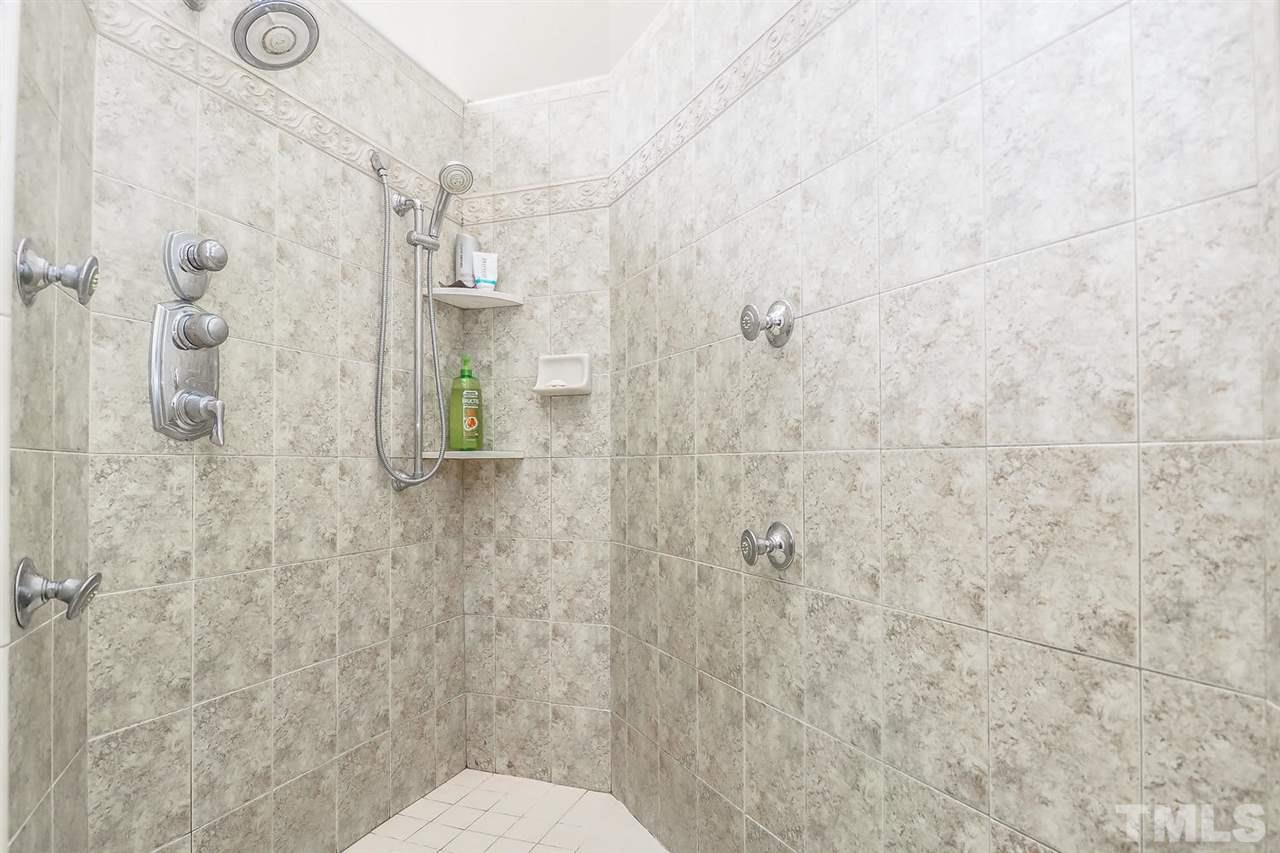 299 Howard Tant Road Zebulon, NC 27597 - Photo 15 of 25 The huge walk-in tiled shower has 2 shower heads & body jets.