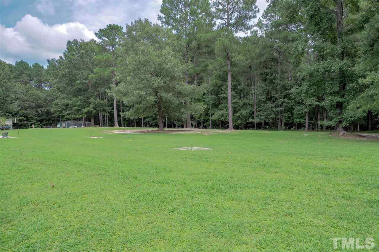 299 Howard Tant Road Zebulon, NC 27597 - Photo 24 of 25 There are garden beds & 2 fenced dog pens in the huge, private backyard that backs to woods.