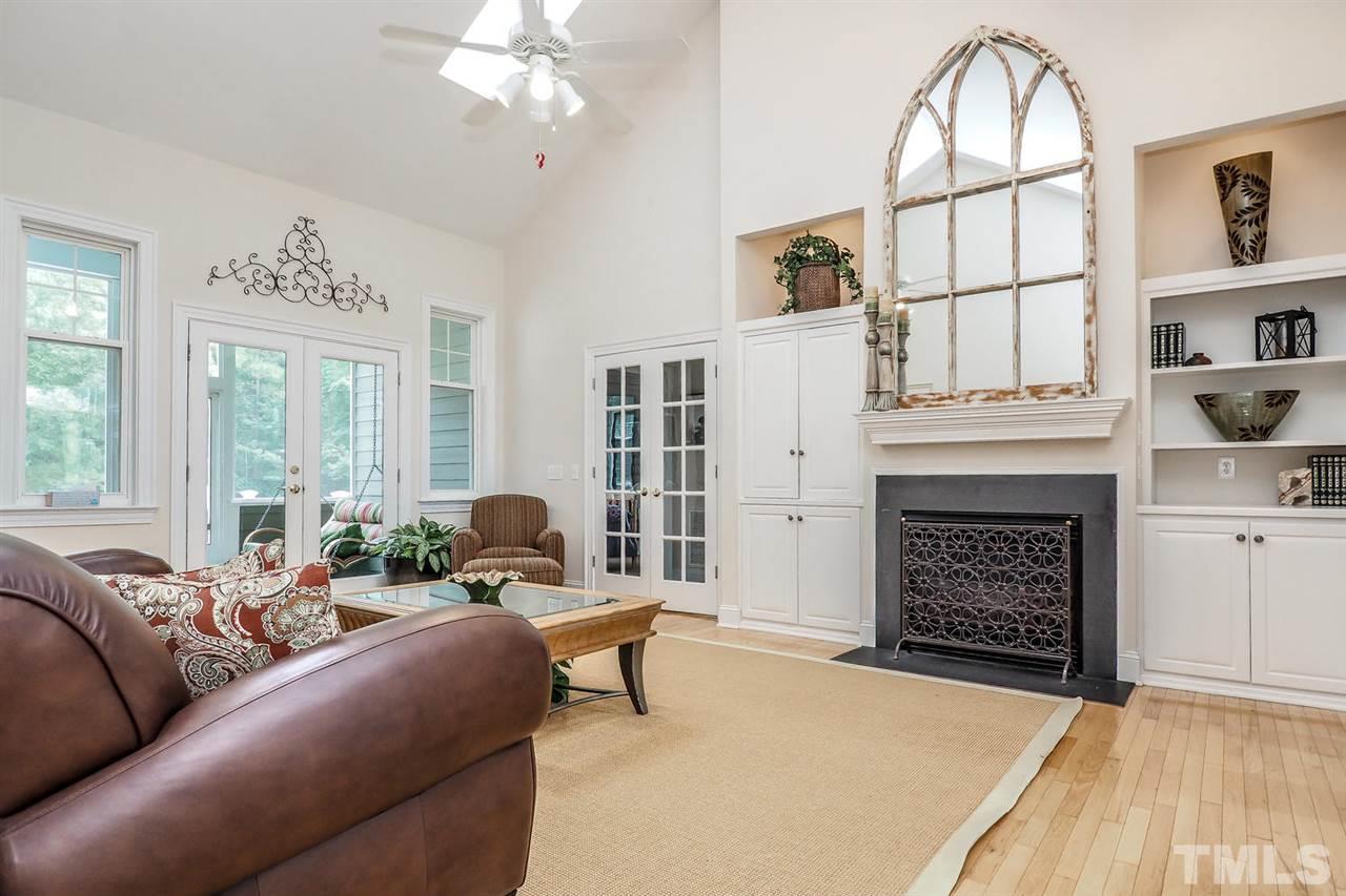 299 Howard Tant Road Zebulon, NC 27597 - Photo 4 of 25 The lg vaulted Living Rm features 2 skylights, CF, recessed lights, FP flanked by built-in cabinetry/bookshelves/display niches & French doors to the Screened Porch.
