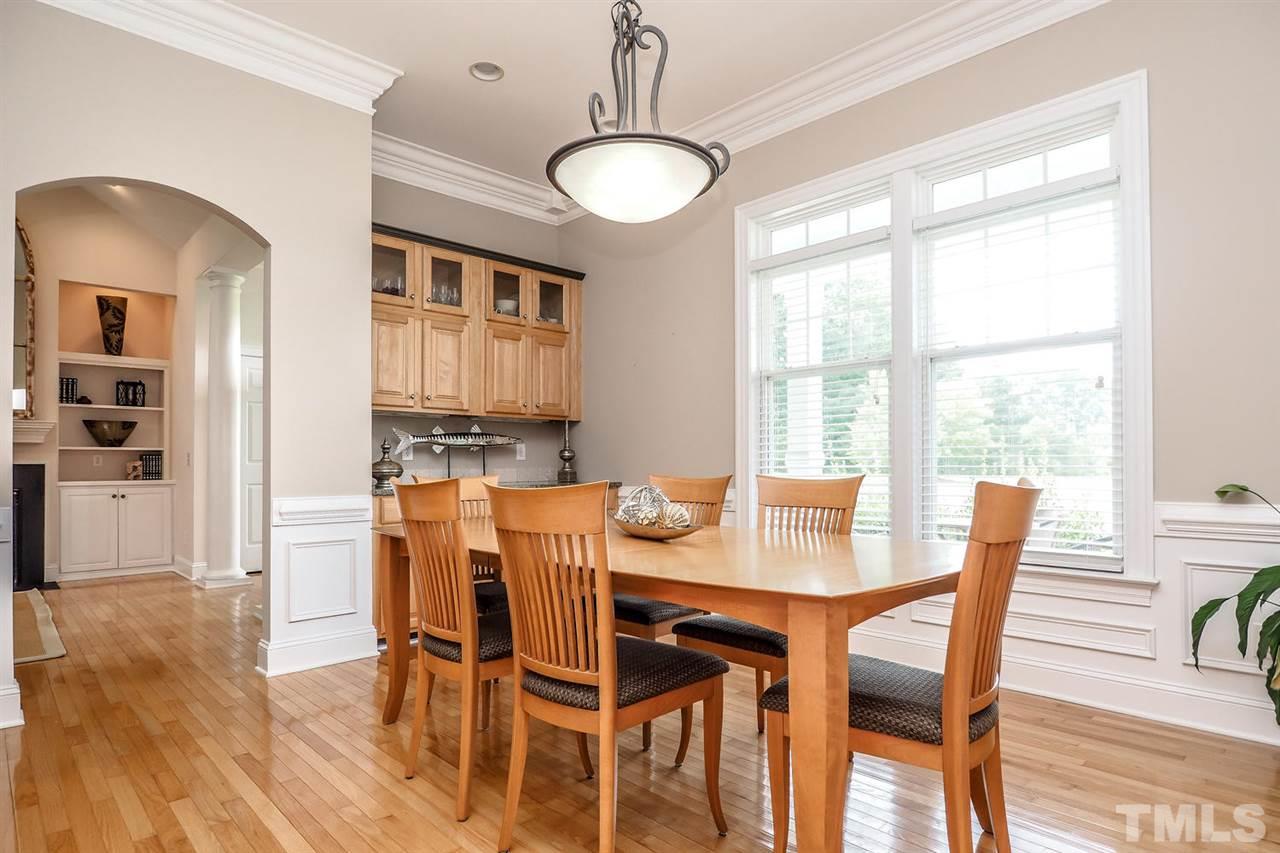 299 Howard Tant Road Zebulon, NC 27597 - Photo 6 of 25 The adjacent formal Dining Rm has a bronze light fixture, panel wainscot, crown/chair rail molding & built-in buffet w/granite top & wall cabinets.