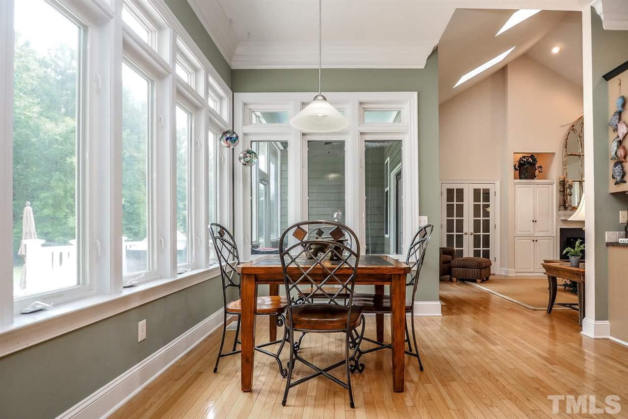 299 Howard Tant Road Zebulon, NC 27597 - Photo 10 of 25 The sunny Bfast nook is surrounded by windows. The nearby Laundry Rm features a neutral tile floor, wall cabinets, built-in ironing board & room for a freezer.