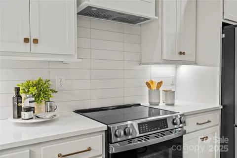 a stove top oven sitting inside of a kitchen