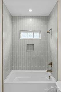 a bathroom with a bathtub and a shower