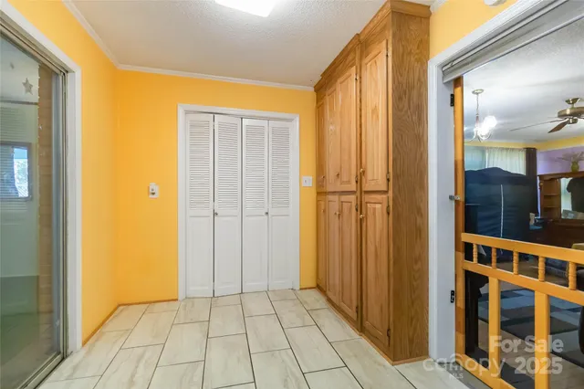 a view of a hallway with wooden shelves