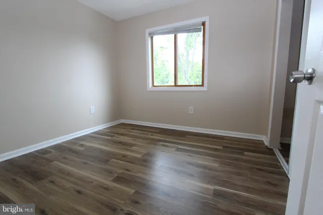 a view of wooden floor in an empty room