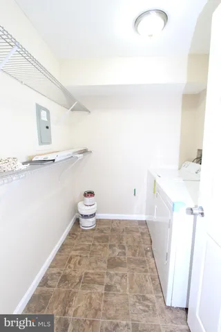 a bathroom with a bathtub shower sink vanity and toilet