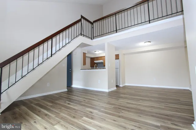 a view of staircase with white walls and wooden floor