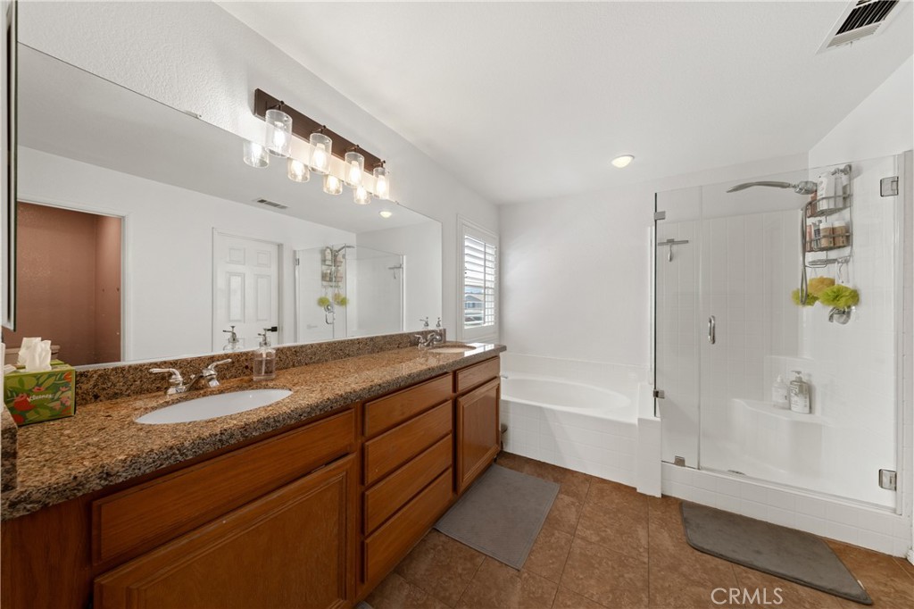 32985 Novara Court Temecula, CA 92592 - Photo 30 of 56 Spacious Primary Bathroom With Dual Sinks, Vanity Seating Area, And Walk-In Shower