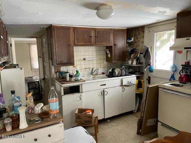 32 North Main Road Otis, MA 01253 - Photo 14 of 30 a kitchen with a sink stove and cabinets