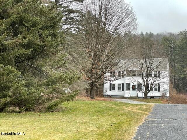 32 North Main Road Otis, MA 01253 - Photo 3 of 30 a front view of a house with a garden