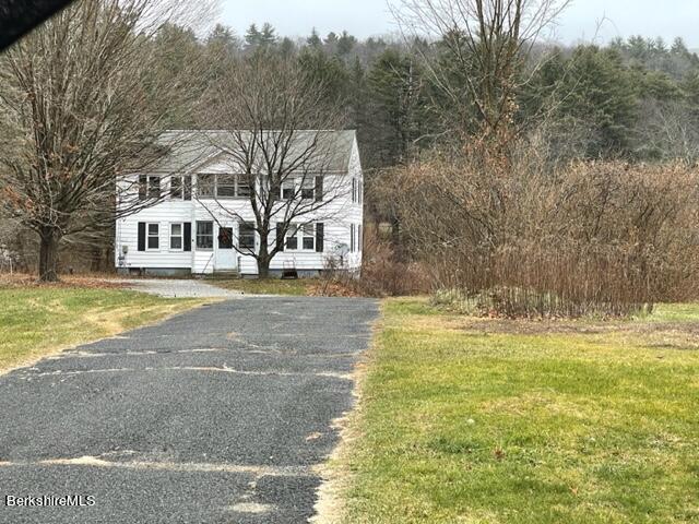 32 North Main Road Otis, MA 01253 - Photo 6 of 30 a front view of a house with a yard and trees