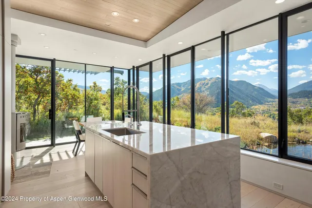 a kitchen with a stove and a wooden floor