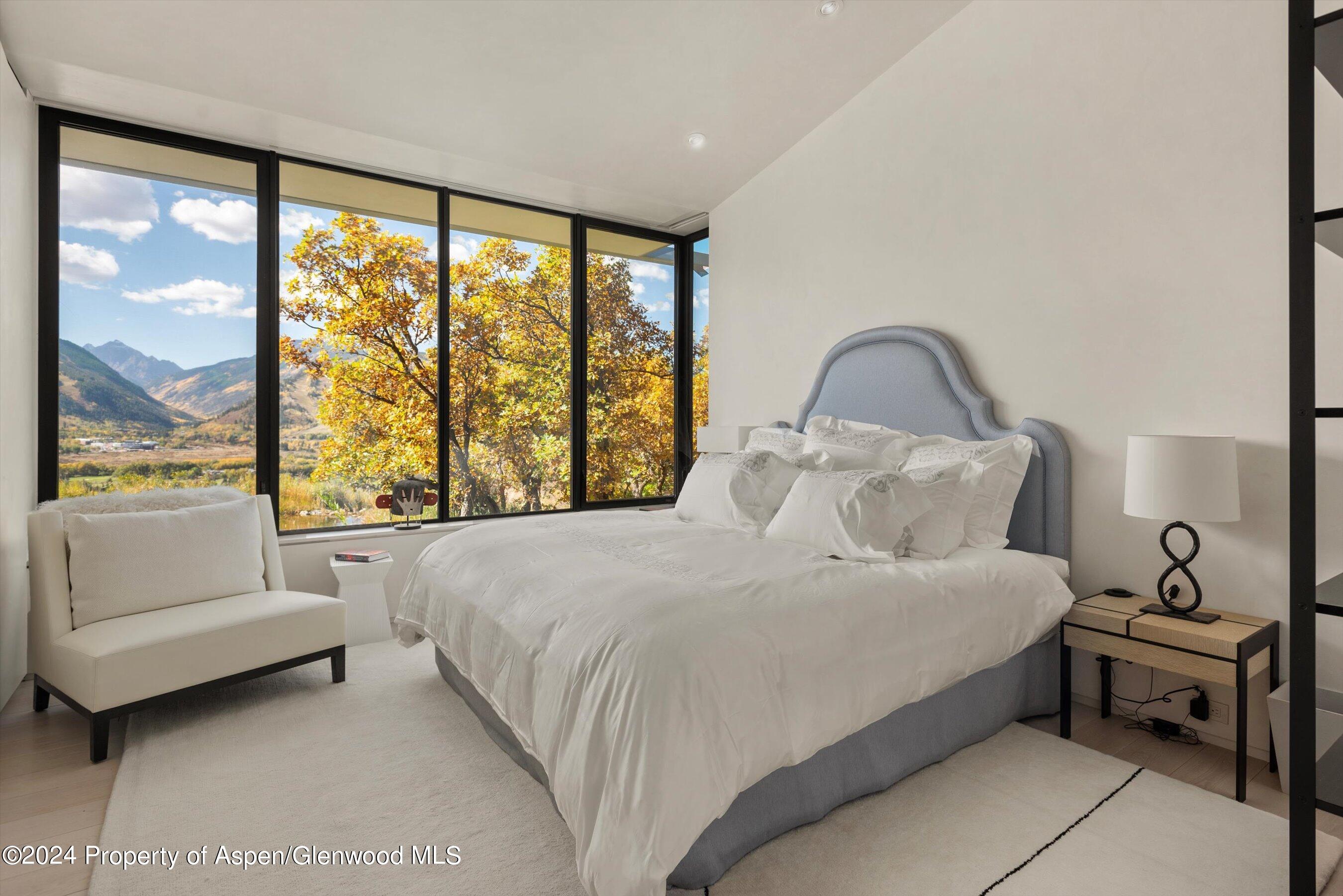 600 Nell Erickson Road Aspen, CO 81612 - Photo 19 of 40 a bedroom with a bed and a large window