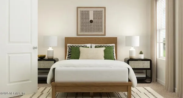 a bedroom with a bed and a lamp