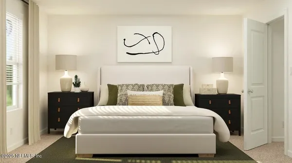 a bedroom with a bed and lamp on dresser
