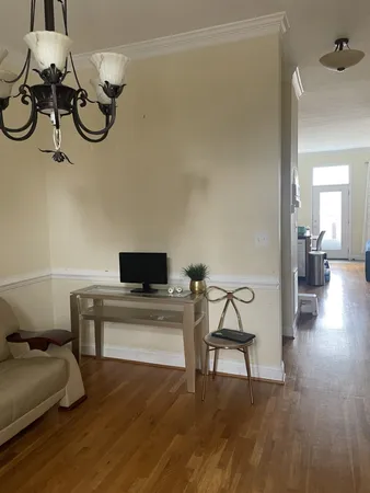 a view of a livingroom with furniture and a chandelier fan