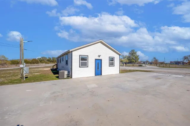a view of the house with a yard and garage