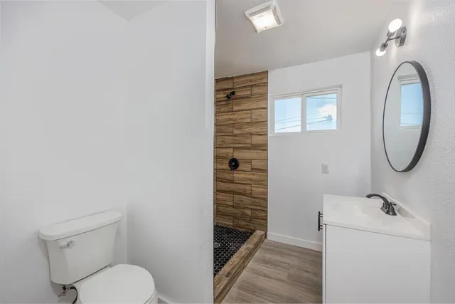 an empty room with a fan and a fan