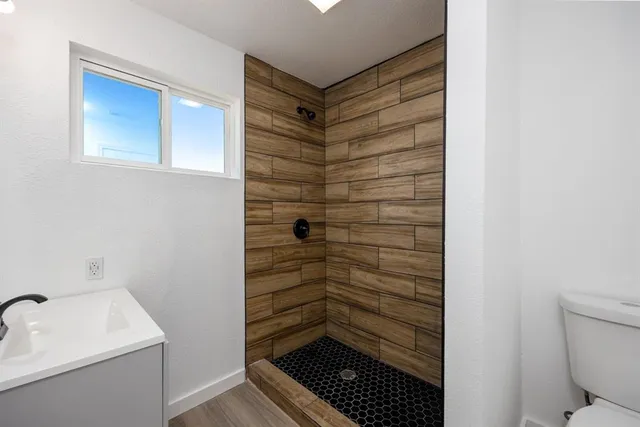 a view of a kitchen with wooden floor and a kitchen view