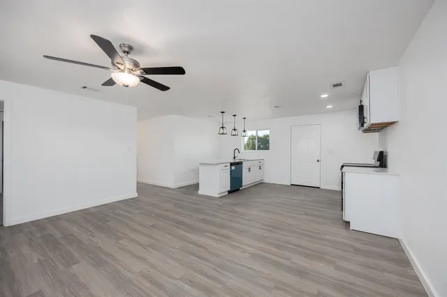 a kitchen with white cabinets and stainless steel appliances
