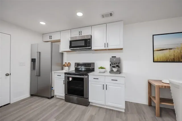 a living room with furniture a rug and a flat screen tv