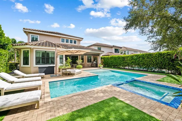 a house view with swimming pool and garden space