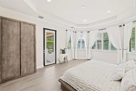 a spacious bedroom with a large bed and a window