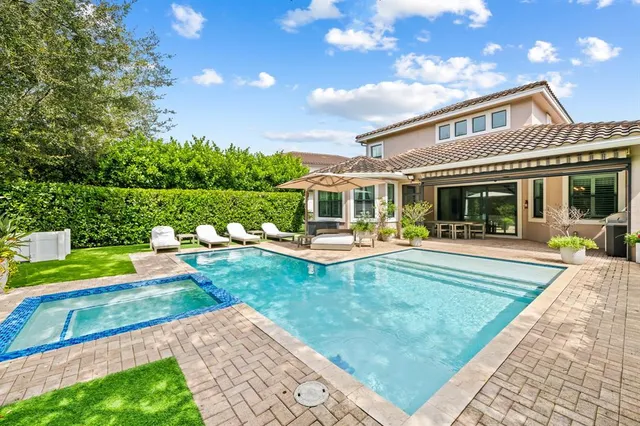 a view of house with swimming pool yard and outdoor seating