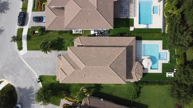 an aerial view of a house with garden space and outdoor seating