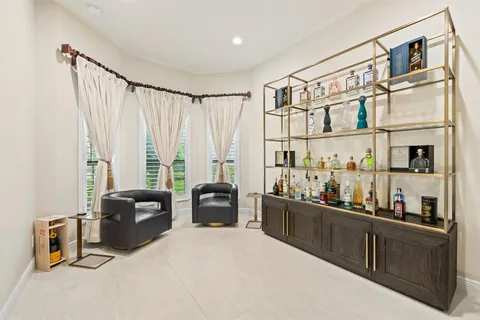 a living room with furniture a flat screen tv and a window