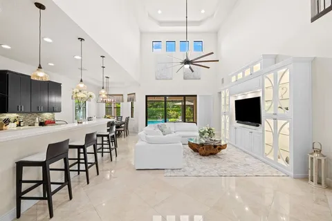 a kitchen with a table chairs stove and white cabinets