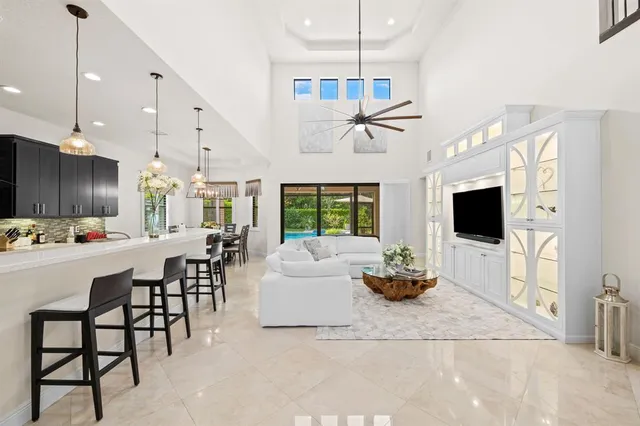 a kitchen with a table chairs stove and white cabinets